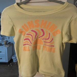 American Eagle Light Yellow Graphic Tee with Orange & Pink Sunburst